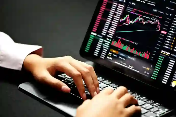 person using black white laptop computer looking at a dummy share market screen to learn money earning