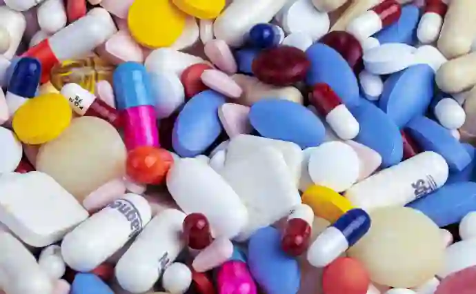 white blue and orange medicine capsules