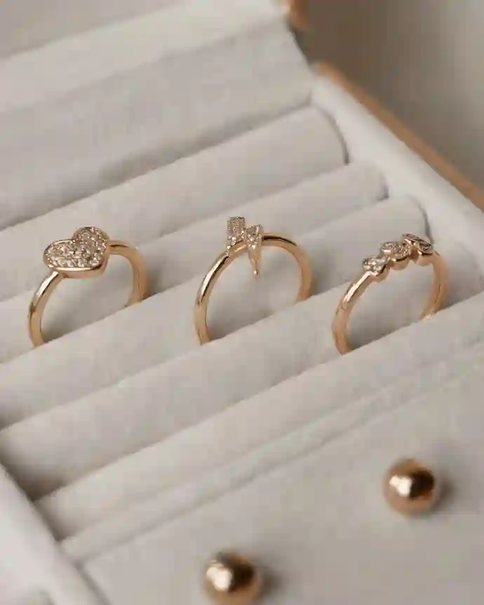 three gold rings in a white box in a jeweller's showroom